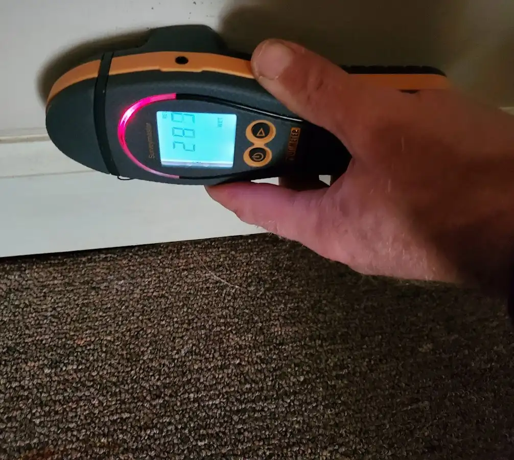 Moisture detection at baseboard during Storm Damage Restoration in Winchester